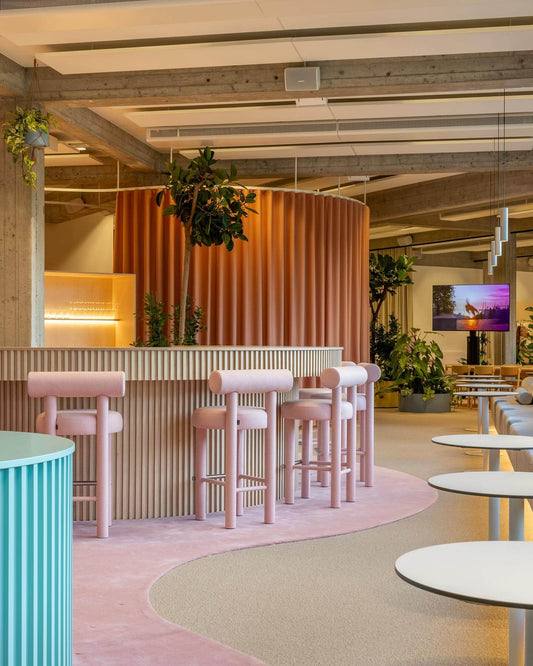 Modern lounge with Gropius CS1 Bar Stools by Noom, designed by Kateryna Sokolova, featuring geometric shapes and Bauhaus-inspired functionalism.