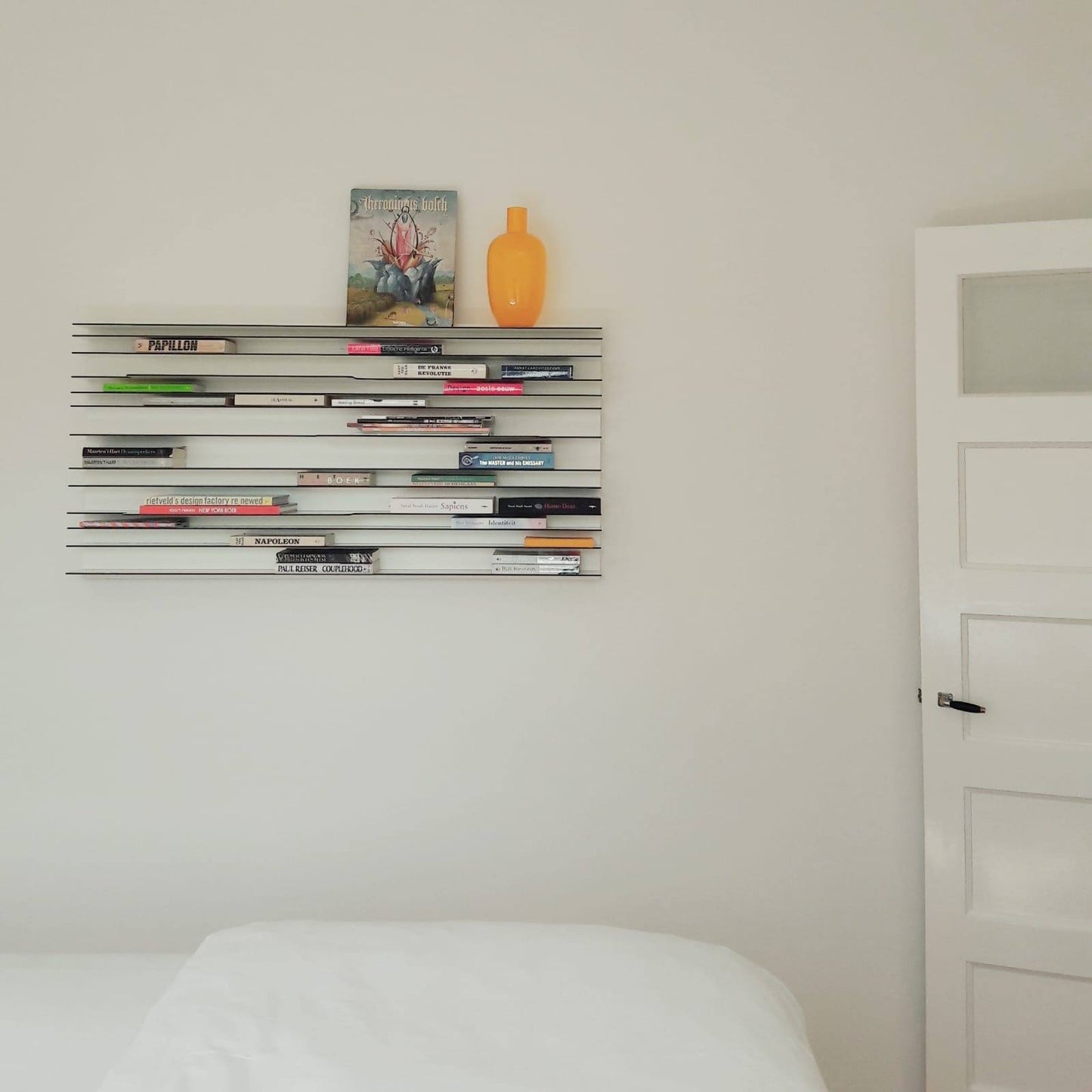 Spectrum Paperback shelving system displaying books and decorative items in a minimalist room setting.