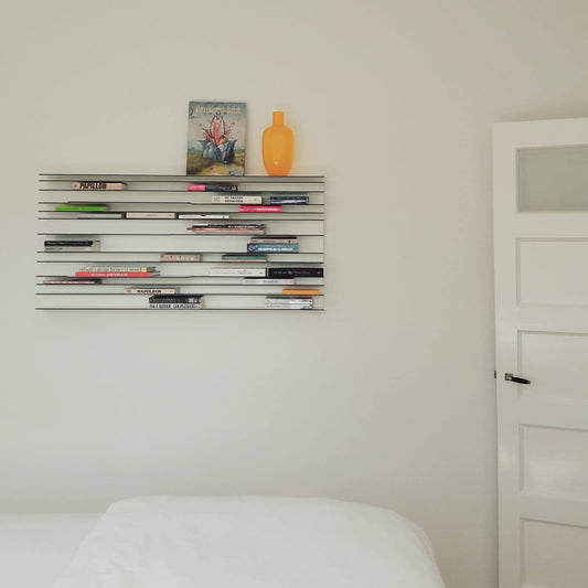 Spectrum Paperback shelving system displaying books and decorative items in a minimalist room setting.