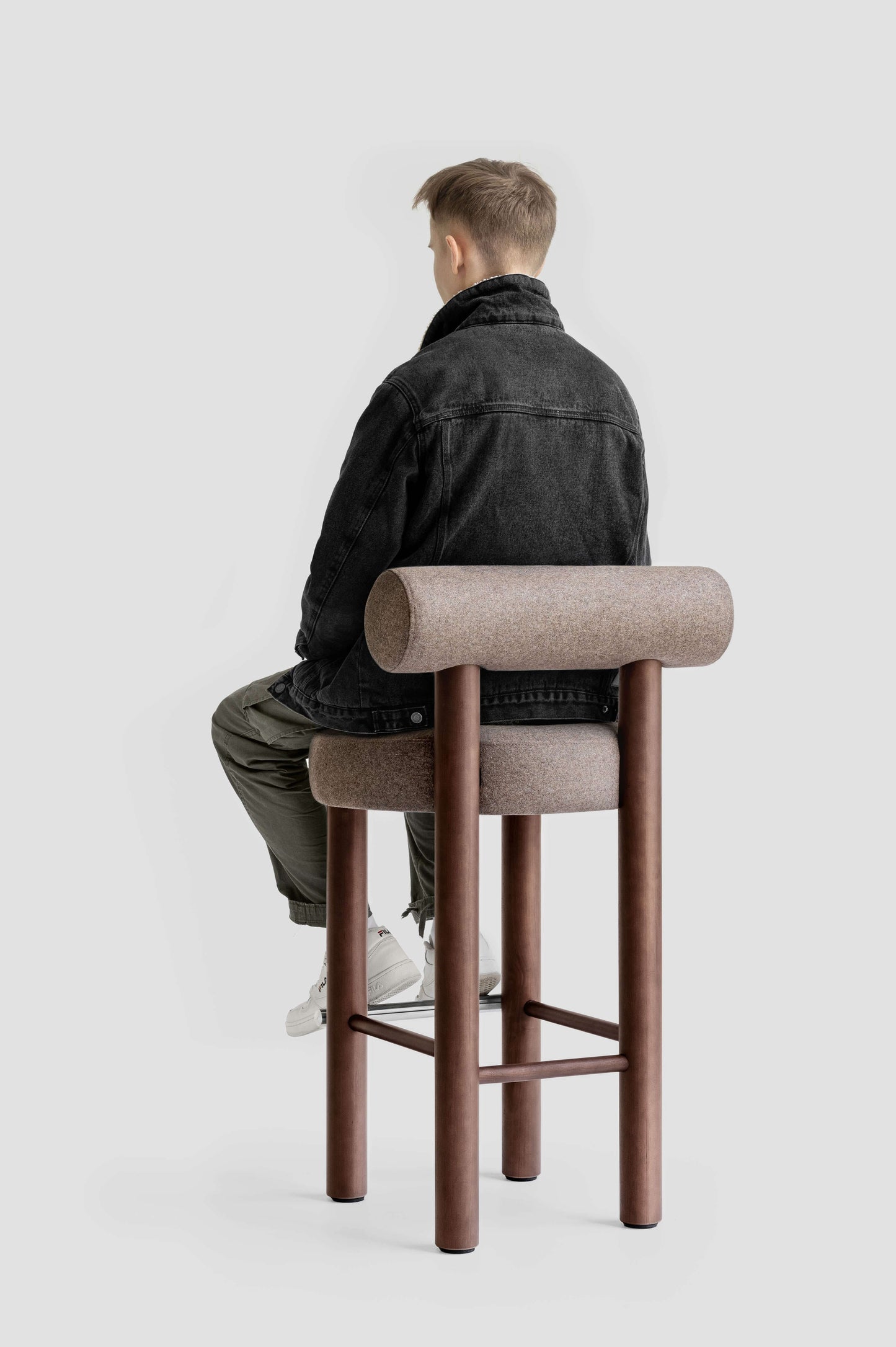 Man sitting on Gropius CS2 Bar Stool designed by Kateryna Sokolova for Noom, celebrating Bauhaus 100th anniversary.