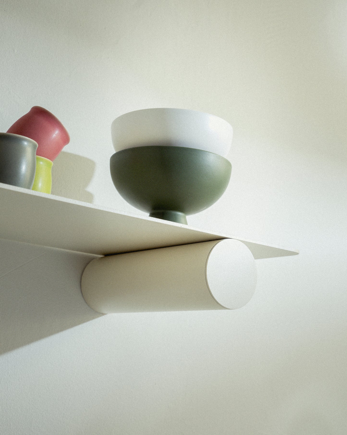 Pipeline Duo shelf by Raawii featuring modern colourful bowls on a sleek metal design.