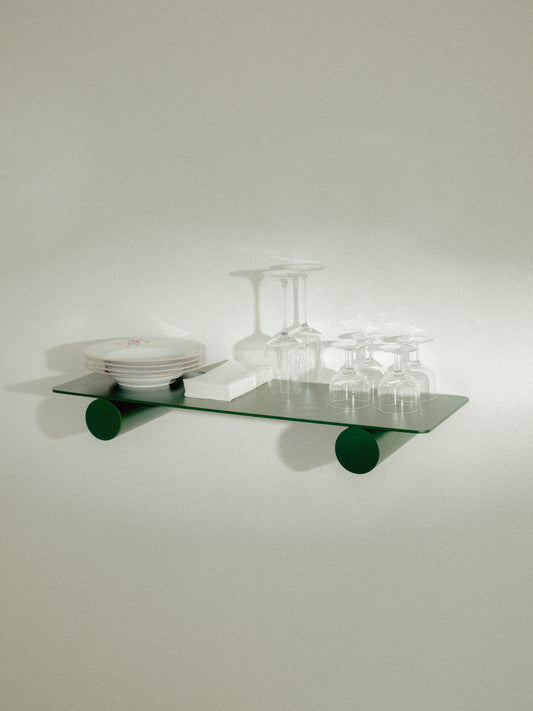 Pipeline Duo shelf by Raawii featuring modern green metal design, showcasing plates and glasses in unique colours.