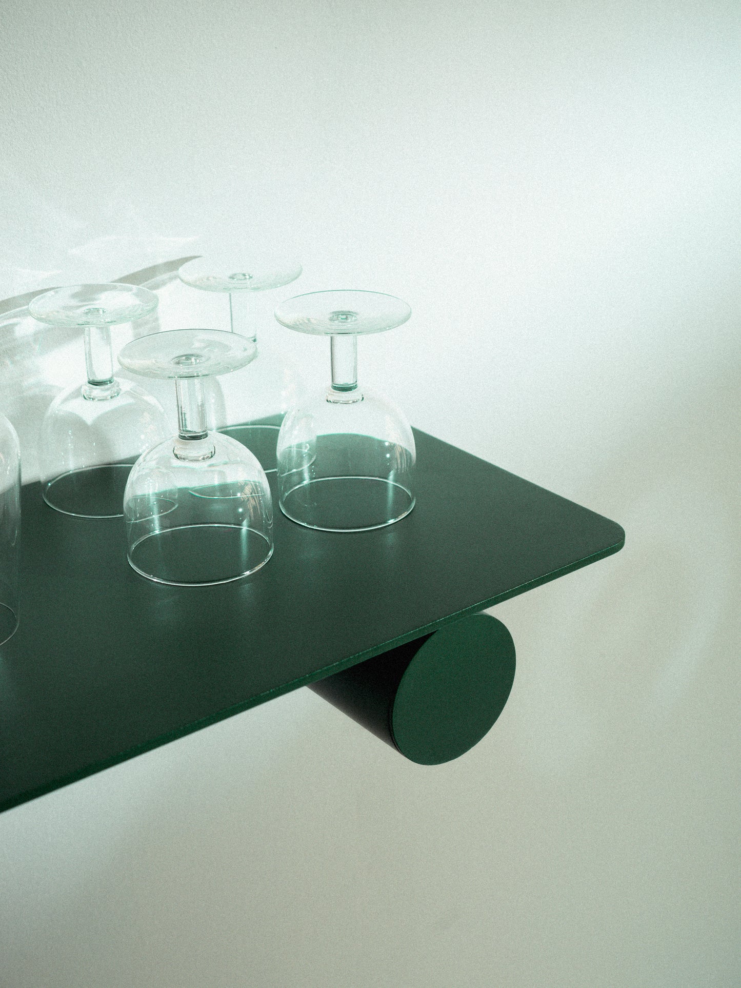 Pipeline Duo shelf by Raawii with glasses, featuring a modern design in unique green colours and metal material.