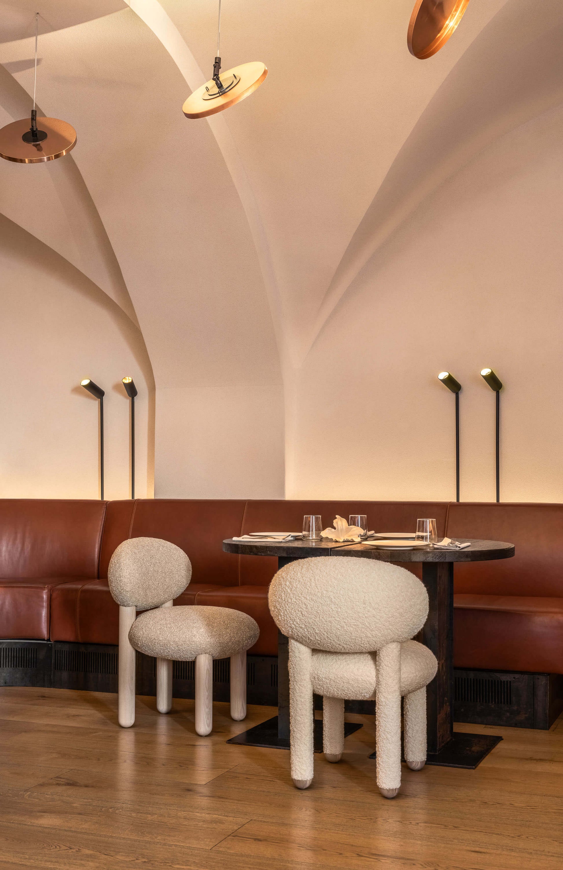 Modern designer Flock dining chairs by Noom, showcasing soft forms in a stylish dining setting.