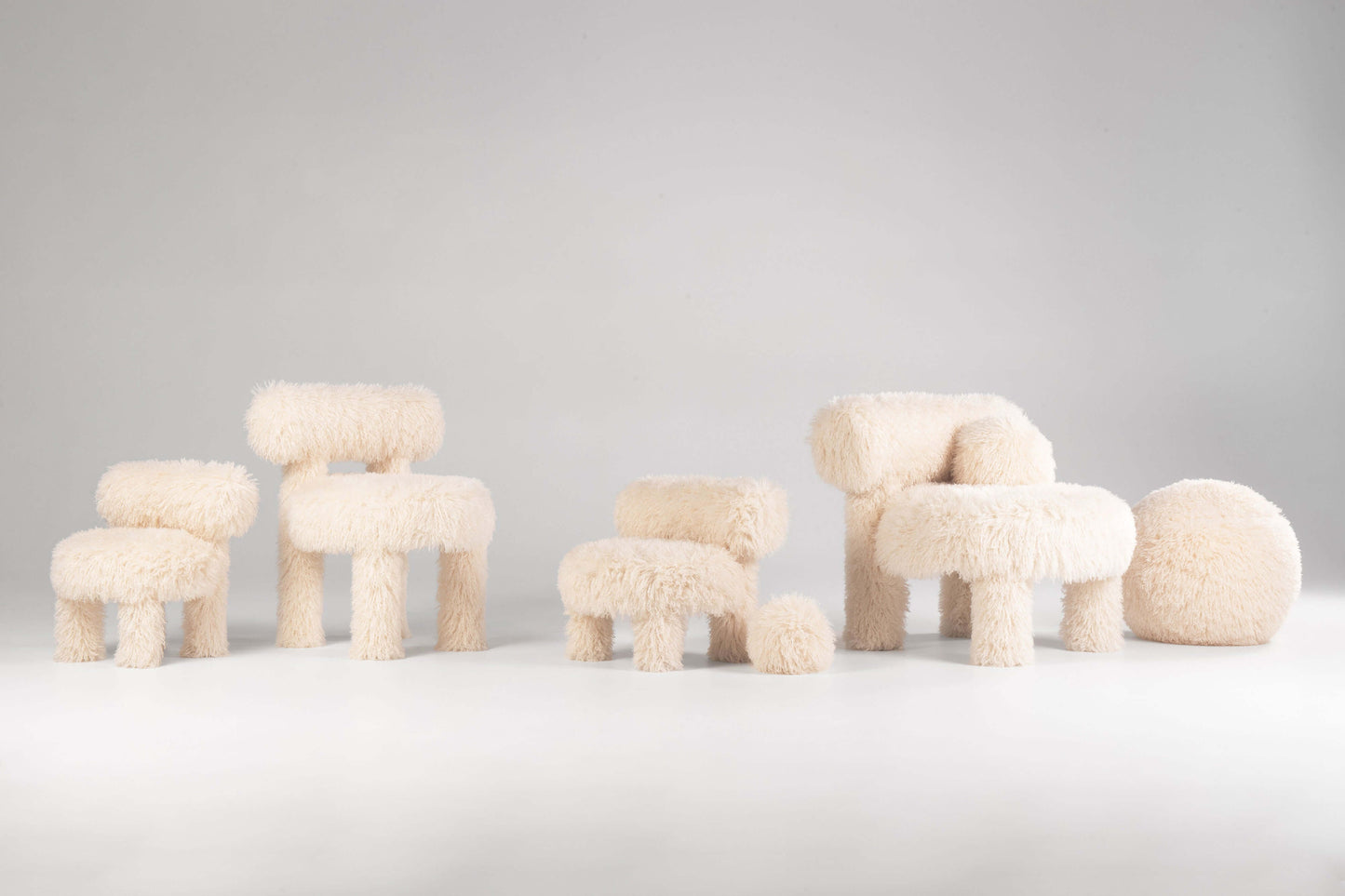 The entire collection of Gropius Dining Chair CS1 Fluffy Editions by Noom covered entirely in white faux fur fabric, showcasing design by Kateryna Sokolova, perfect for modern interiors