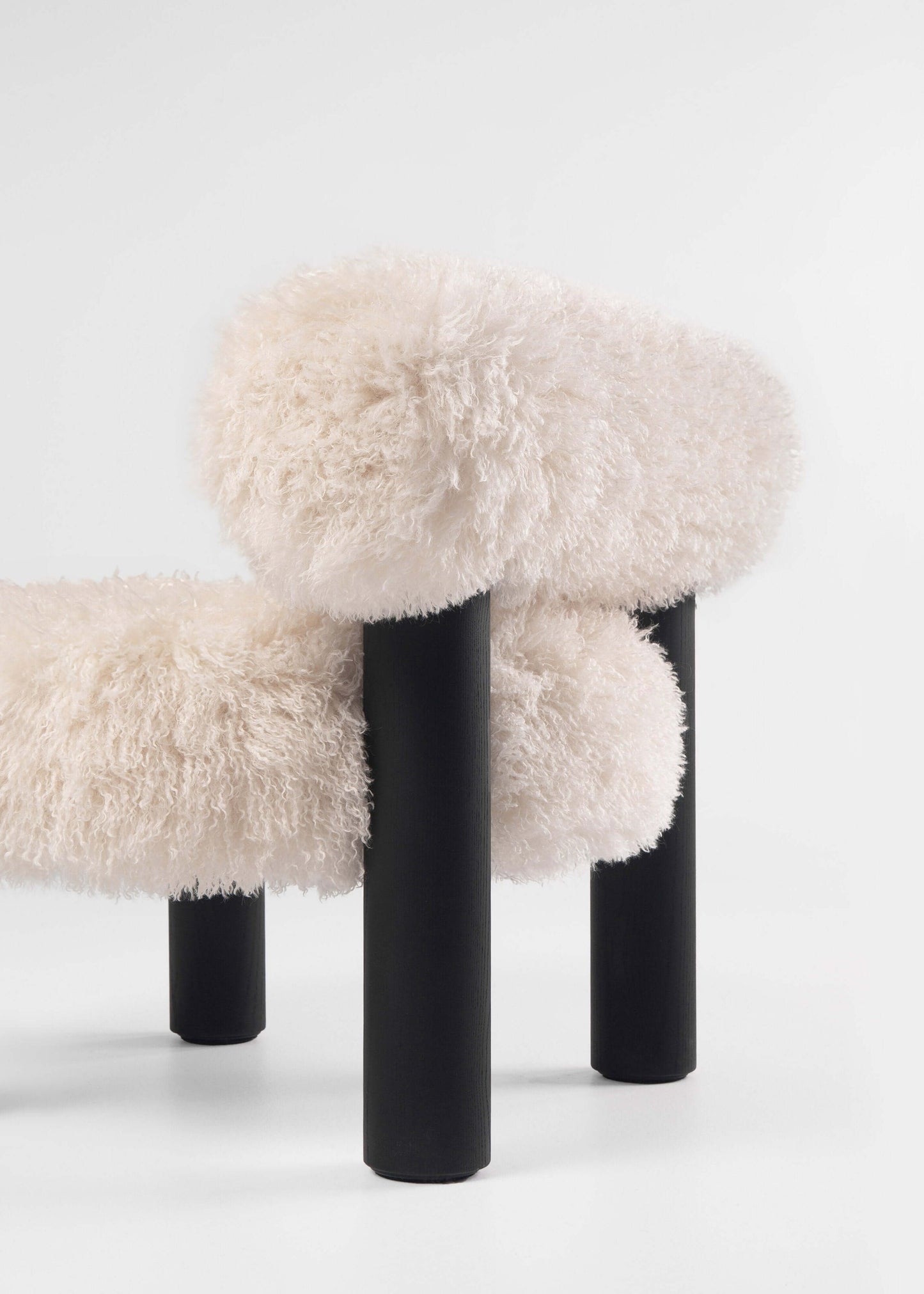 Gropius Low Chair CS2 Fluffy Edition by Noom with plush white upholstery and sleek black legs, perfect for modern interiors.