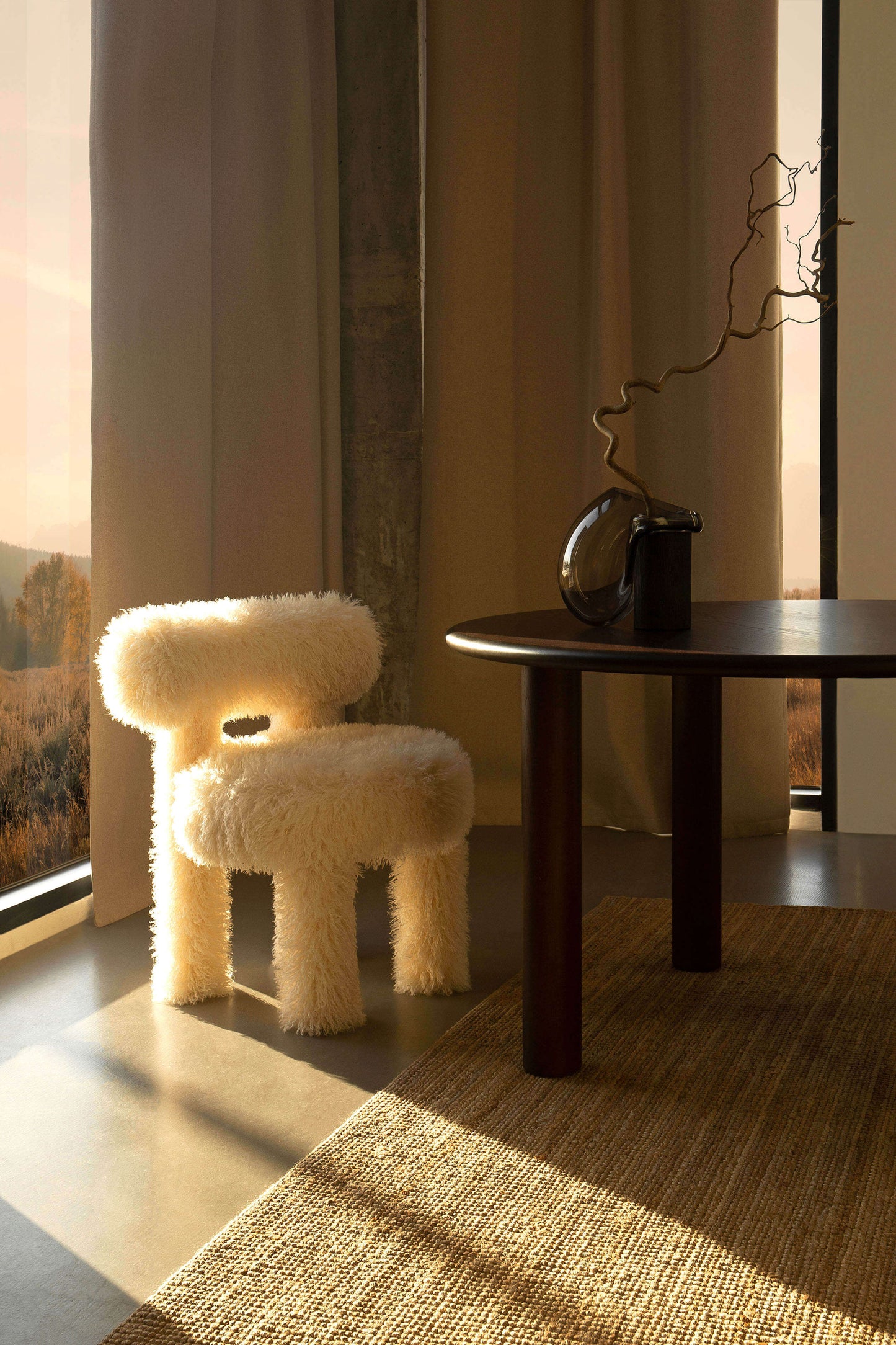 Gropius CS1 Fluffy Edition chair by Noom with cozy design, perfect for stylish interiors, bathed in warm sunlight beside a modern table.