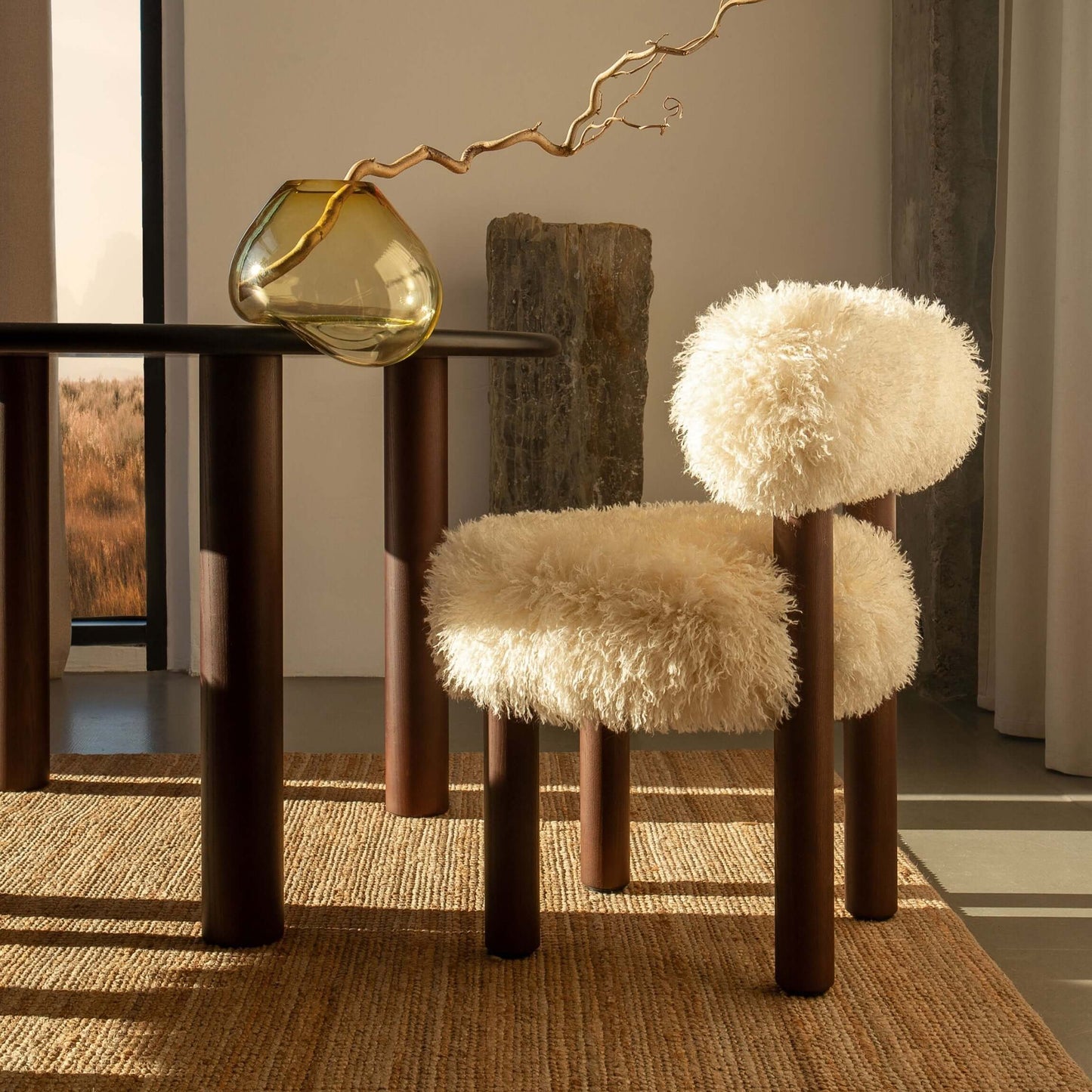 Modern interior with Gropius CS2 Fluffy Edition chair by Noom beside a wooden table, featuring a plush, fluffy design in a cozy setting.