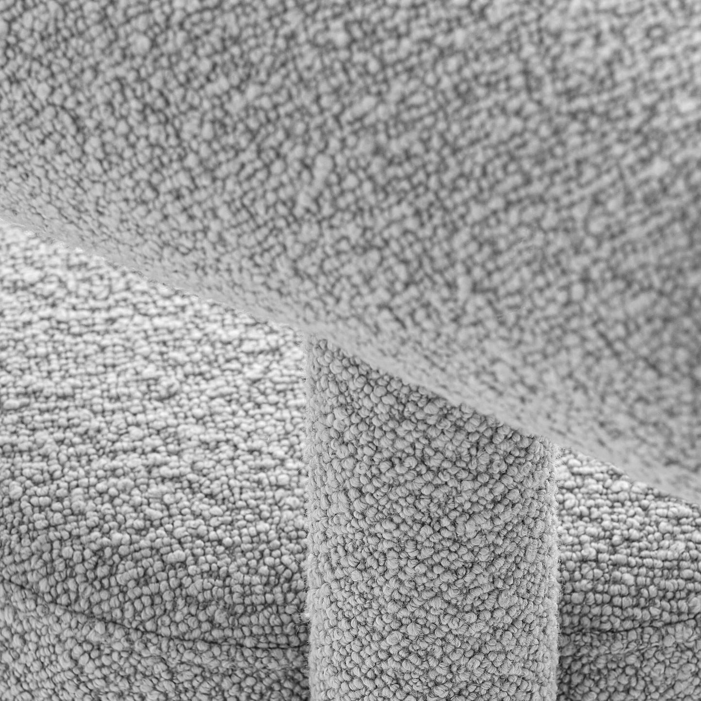 Close-up of textured fabric on the Gropius Low Chair CS1 by Noom, designed by Kateryna Sokolova, inspired by Bauhaus geometric shapes.