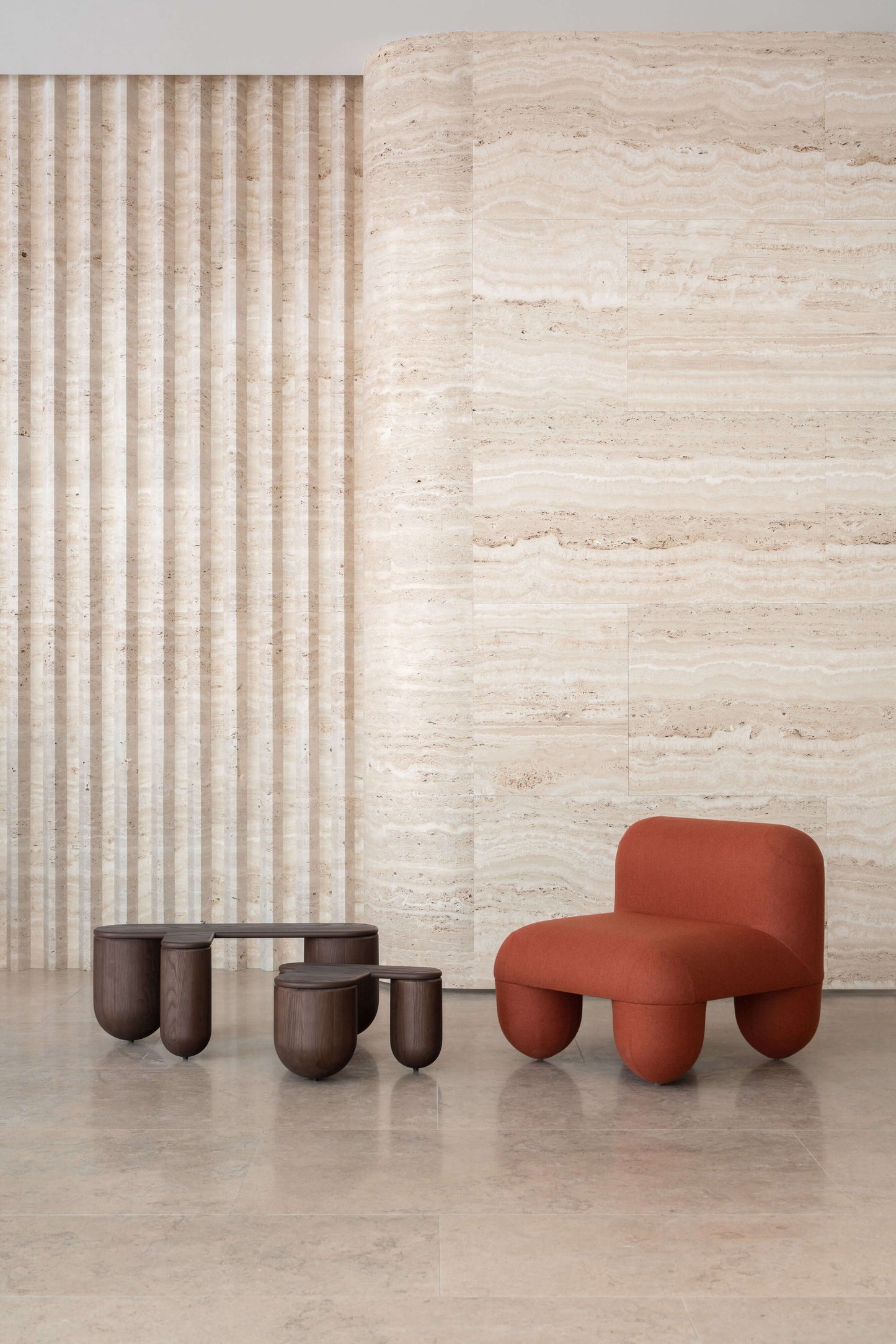 Hello Low Chair by Noom designed by Denys Sokolov, featuring round organic shapes and a deep comfortable seat, in a modern minimalist setting.