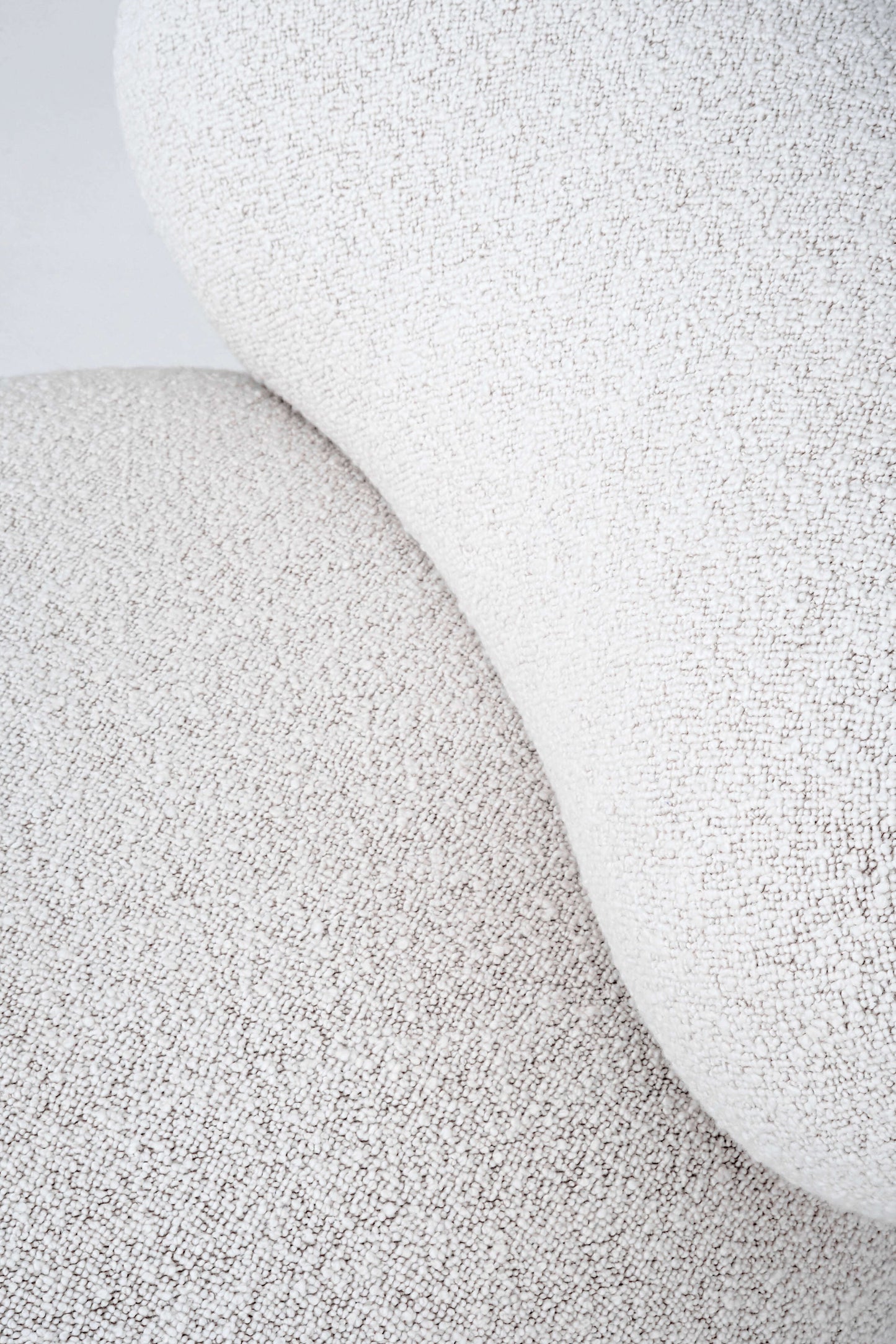 Close-up view of soft textured fabric on the Flock Lounge Chair by Noom, showcasing comfort and natural materials.