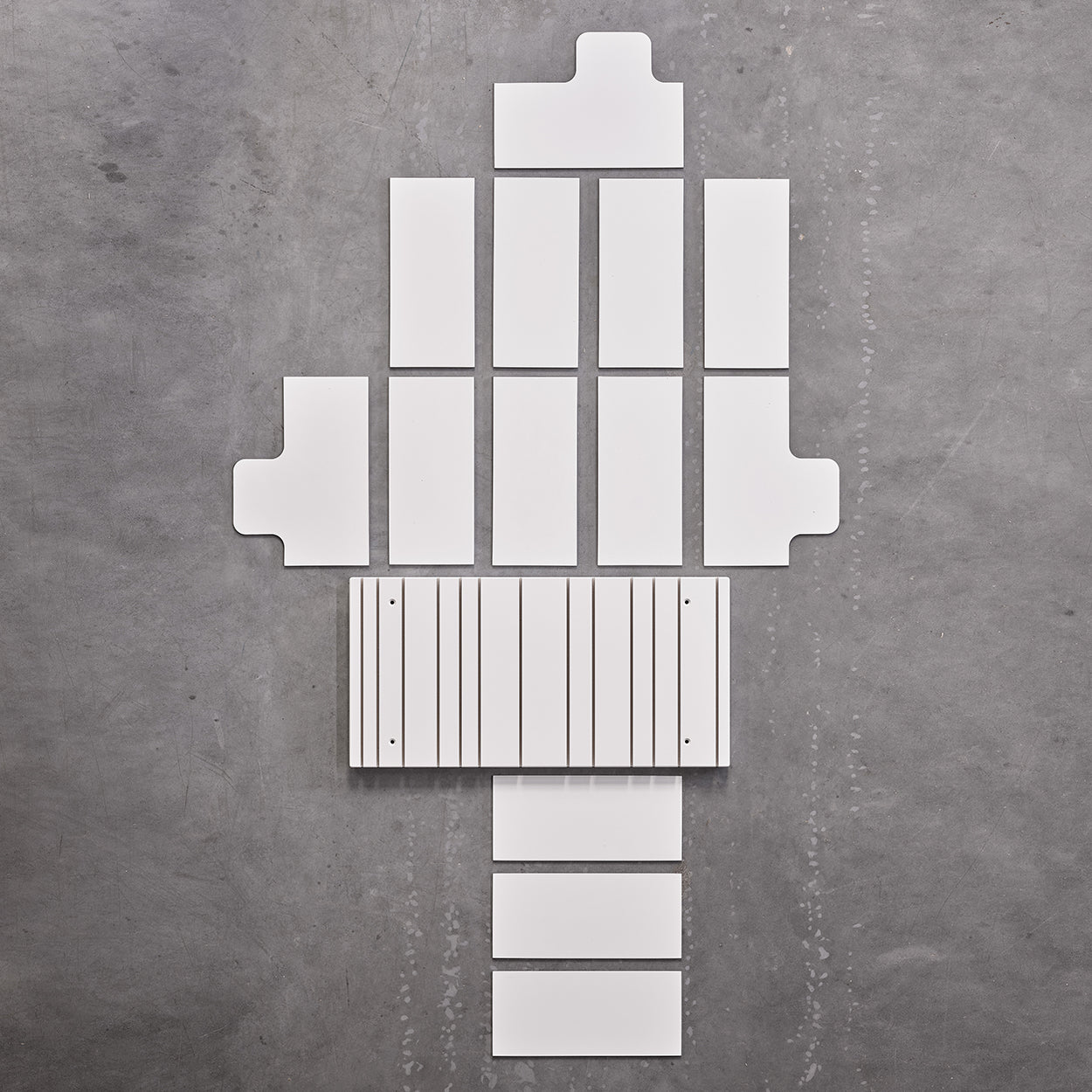 Spectrum Paperback shelving system components arranged neatly on a gray background, showcasing modern design elements.