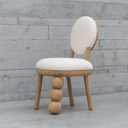 Three Ball Leg Chair designed by Joana Teixeira, showcasing sculptural modern design with unique wooden spheres.