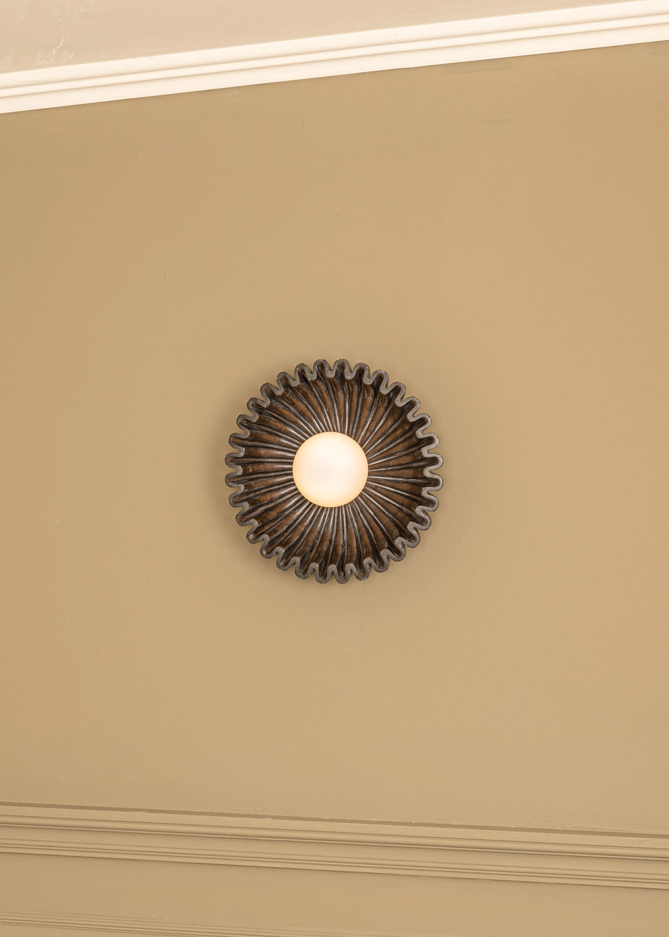 Designer wall sconce with circular design and warm light, ideal for modern interior decor.