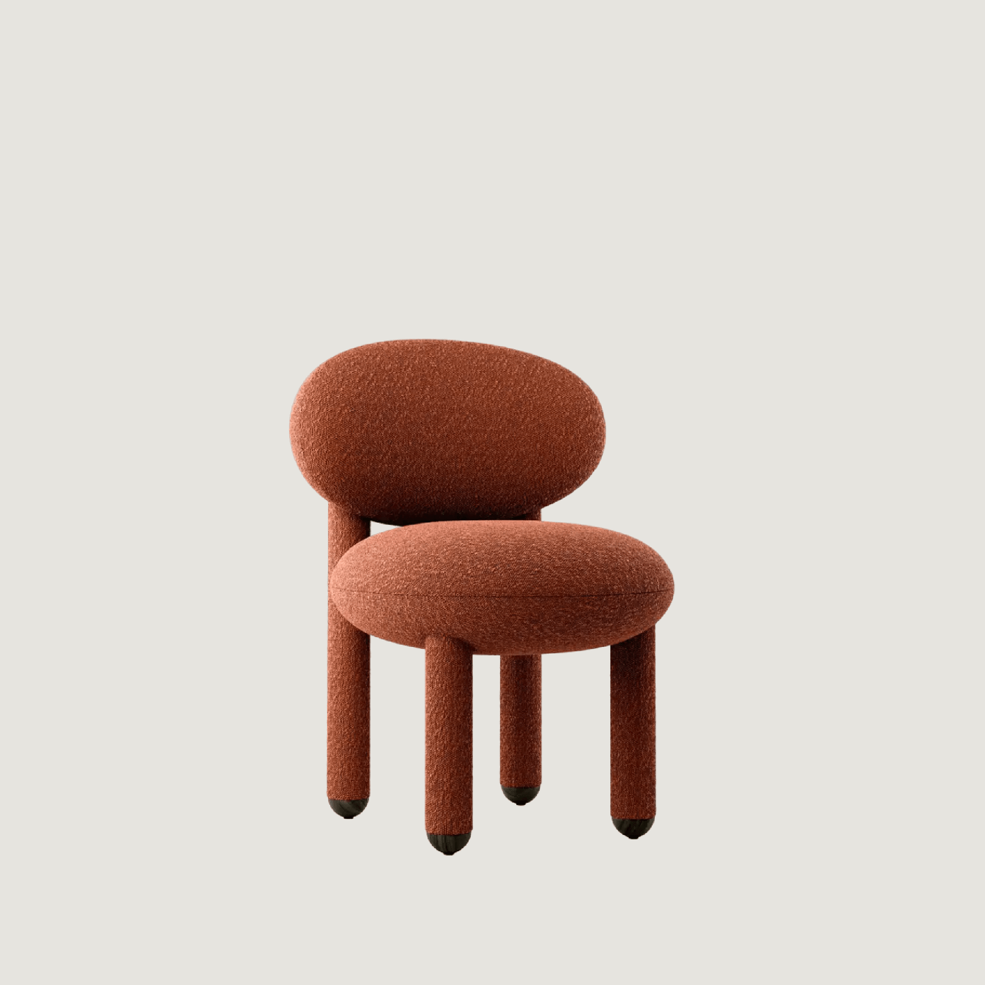 Modern designer Flock dining chair by NOOM home, featuring plush, rounded forms and a warm terracotta hue.