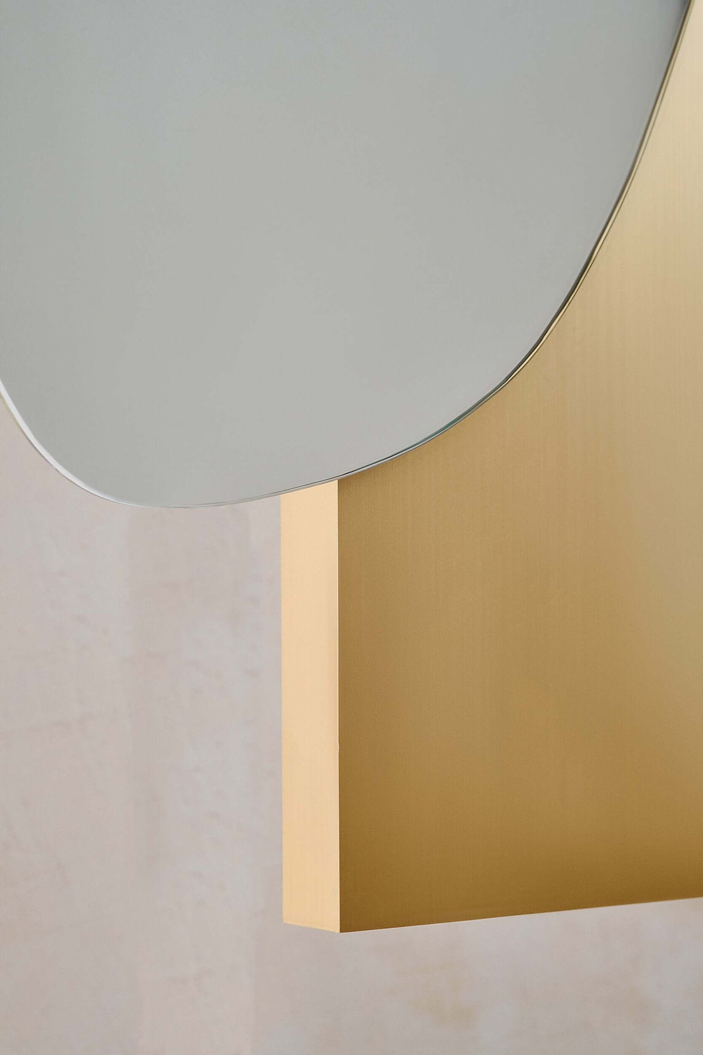 Close-up of Lake Mirror 2 by Noom in sottsass veneer by Alpi, featuring stainless steel and marble with fluid, sculptural design.