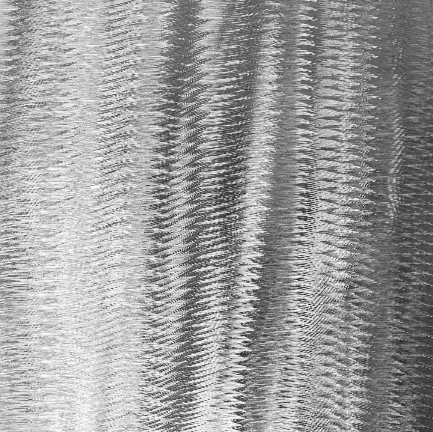 Textured stainless steel surface with wavy pattern.