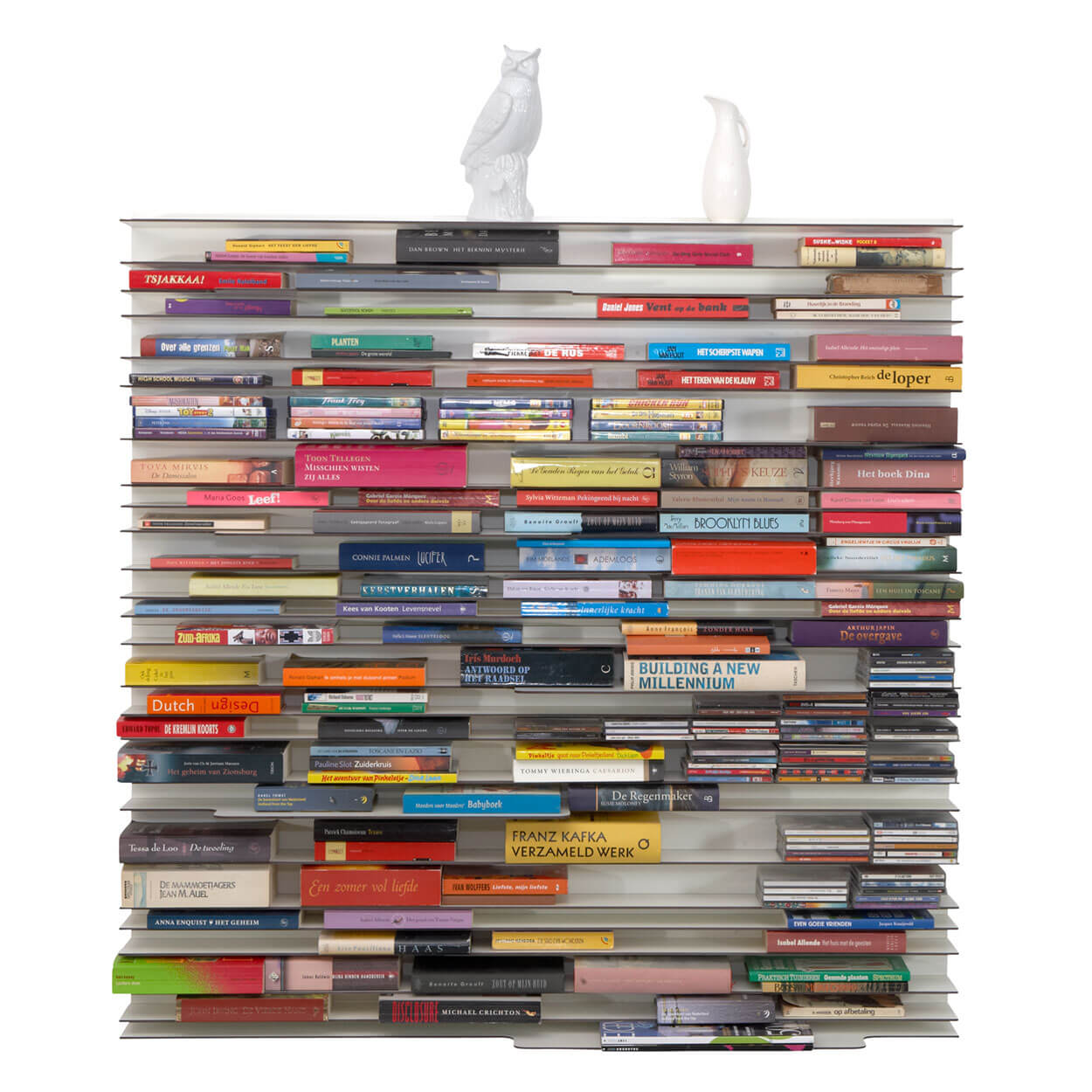 Spectrum Paperback shelving system displaying colorful books with decorative objects on top.
