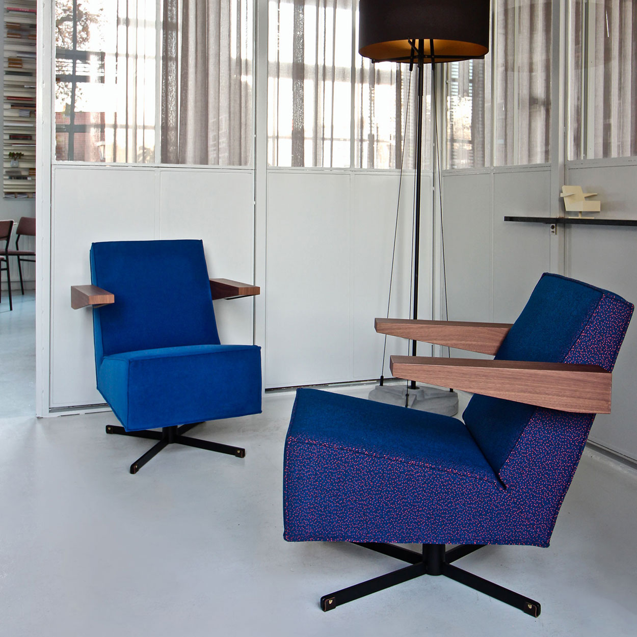 Spectrum Press Room Chairs designed by Gerrit Rietveld in a modern interior setting with stylish blue upholstery.