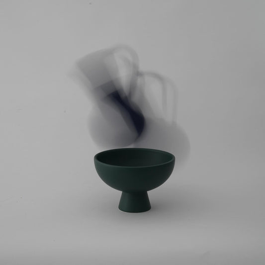 Green ceramic bowl on a white background