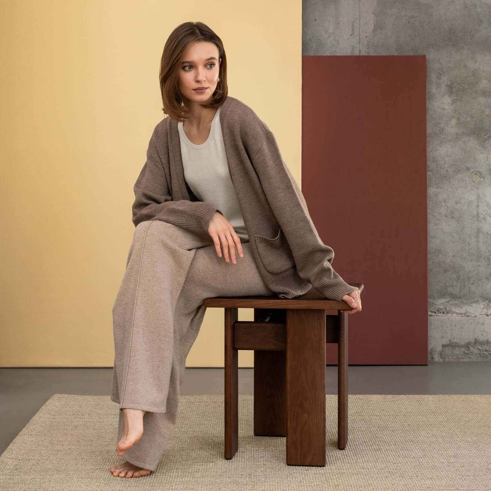 Archipen Table 1 showcased with a model in stylish loungewear, reflecting modern, architectual design by Noom Home.