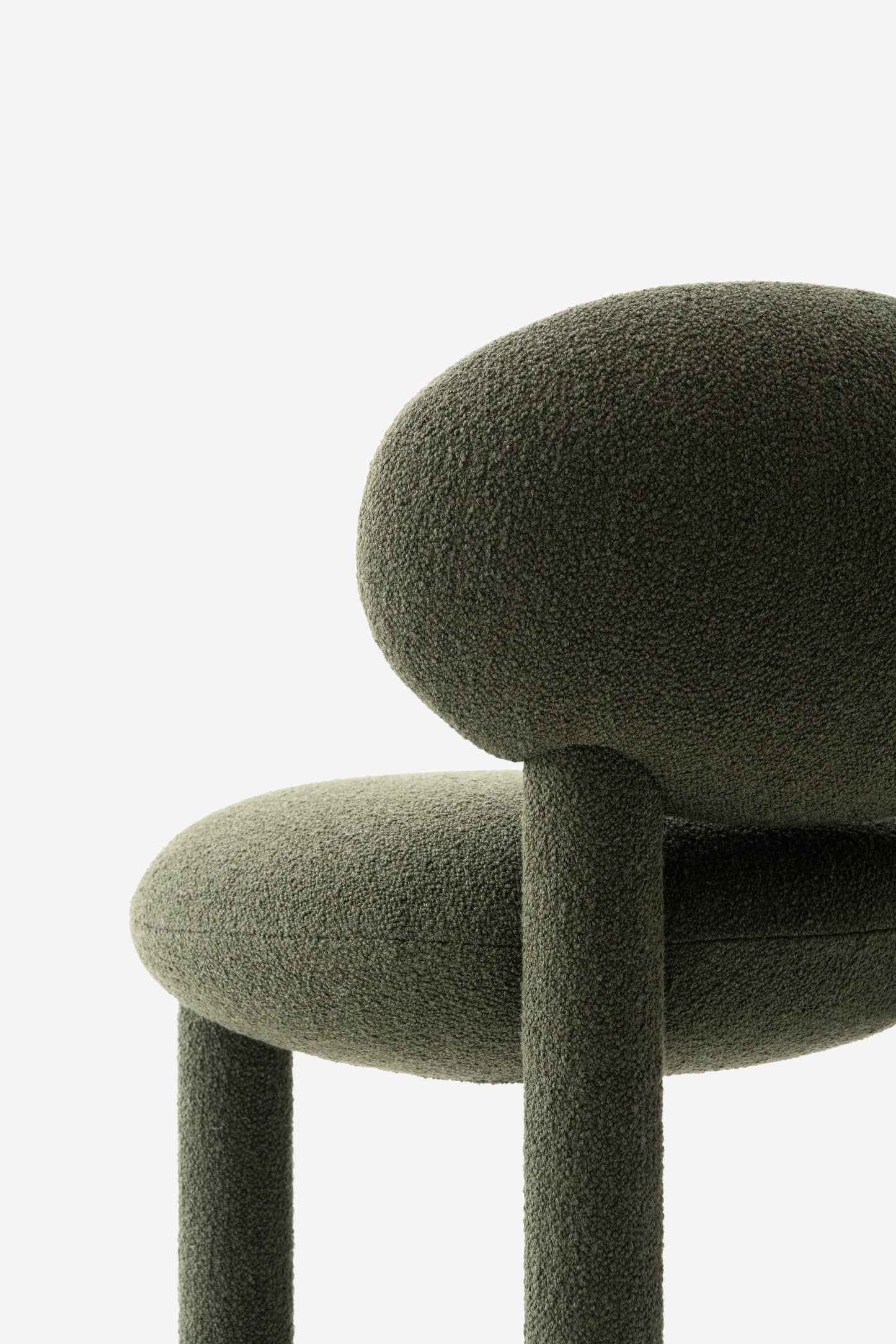 Modern designer Flock CS1 bar stool by Noom with soft green upholstery and curved back support.