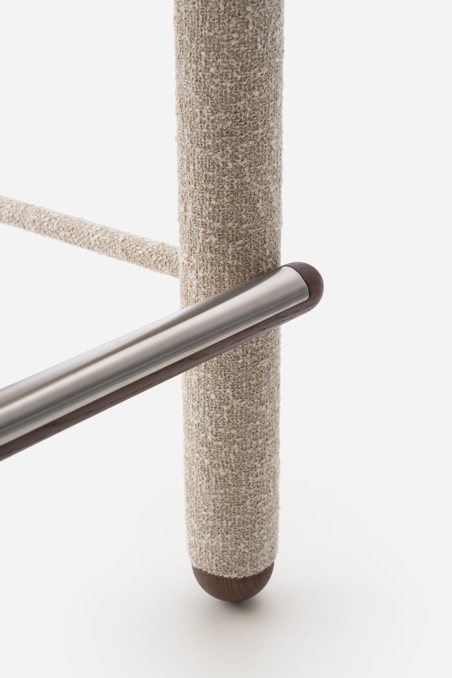 Close-up of the Flock CS1 Bar Stool's textured fabric leg and metallic support, showcasing modern design by Noom.