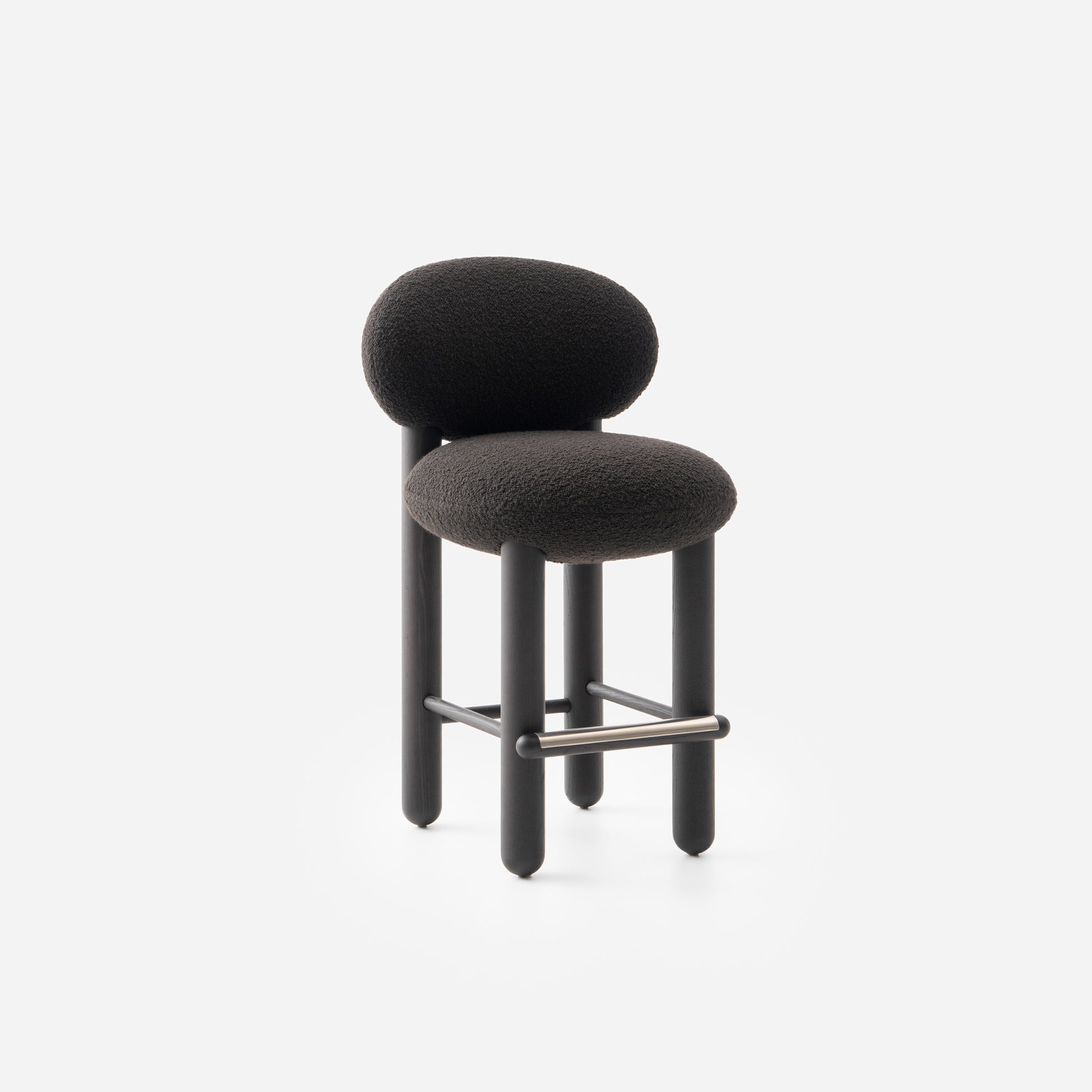 Modern designer Flock CS2 bar stool by Noom with soft black upholstery and curved backrest, perfect for home interiors.