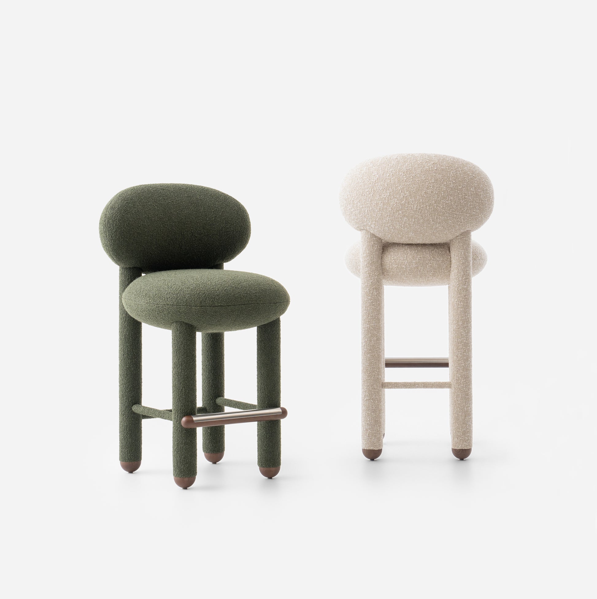 Modern designer Flock CS1 bar stools by Noom in green and cream fabrics, showcasing elegant curves and soft seating.