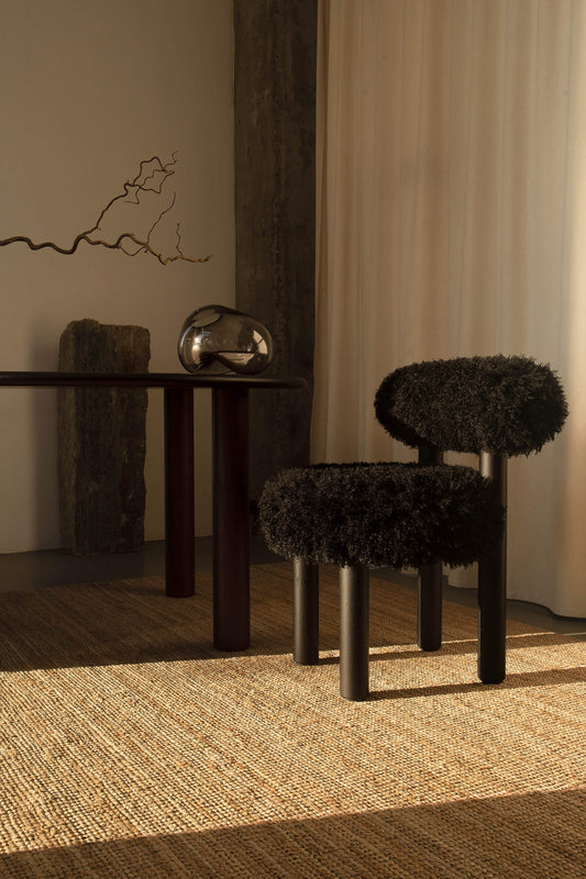 Gropius CS2 Fluffy Edition accent chair by Noom in a modern interior, featuring a sleek black fluffy design and minimalist decor.