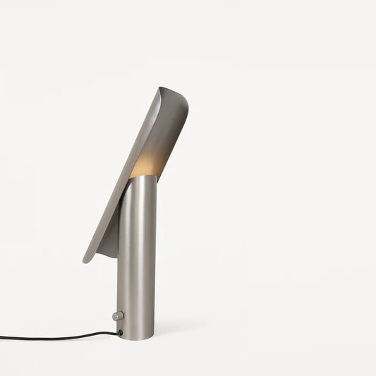 Modern designer metal table lamp by FRAMA, featuring a brushed steel finish and adjustable light angle.